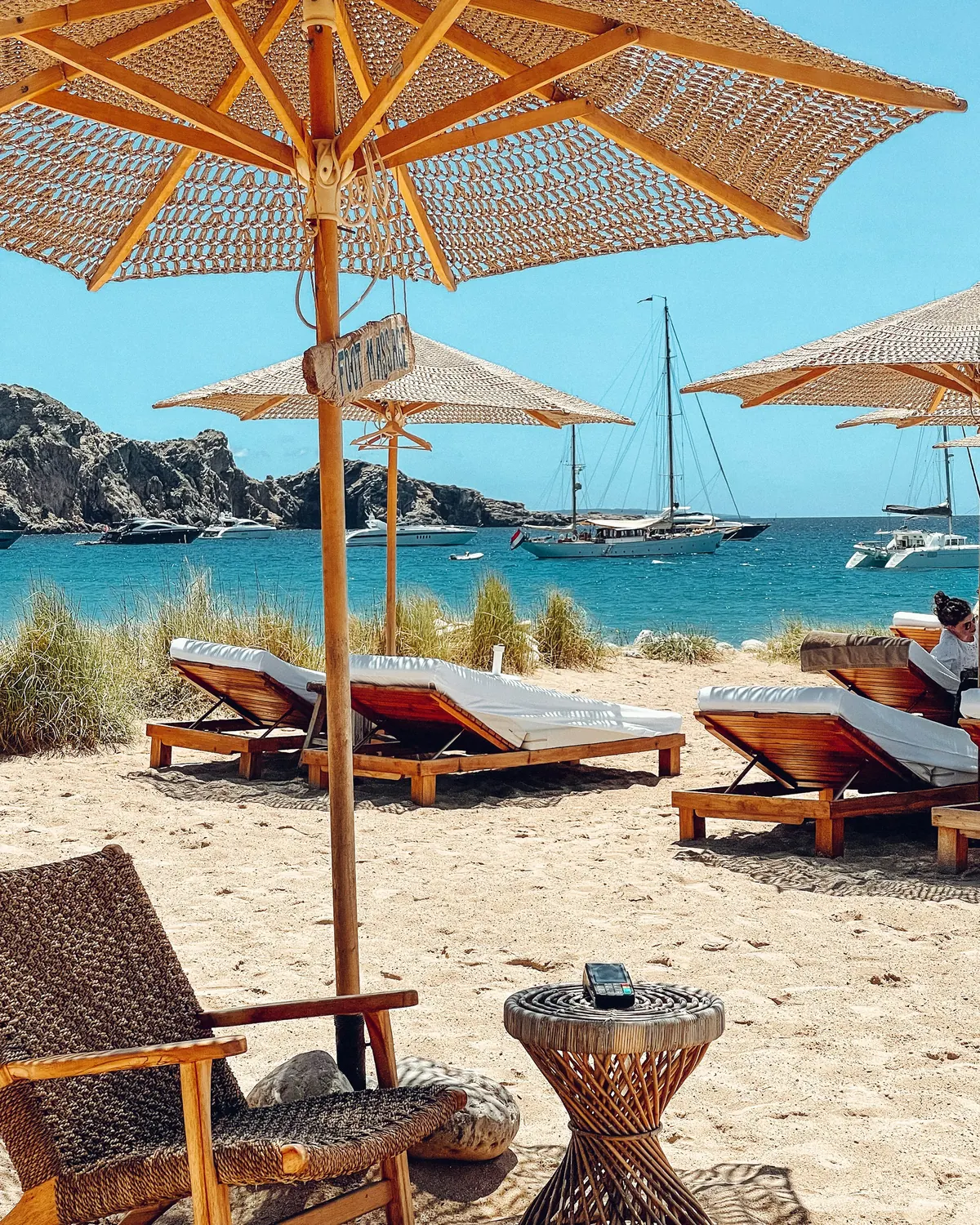 Loungers and a parasol on a beach club terrace